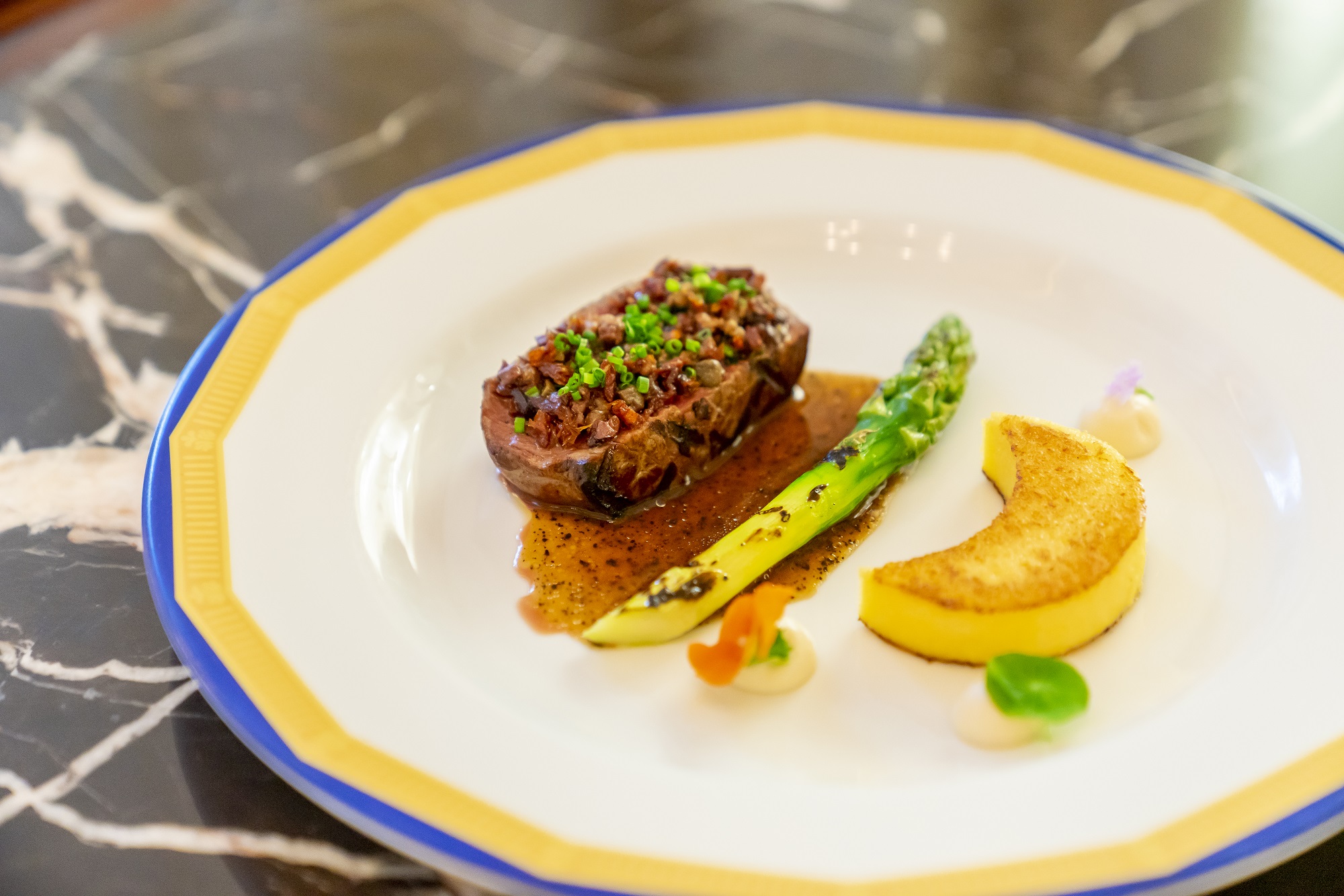 Roasted US beef tenderloin with polenta cake, black olives, anchovies and Barolo jus.jpg